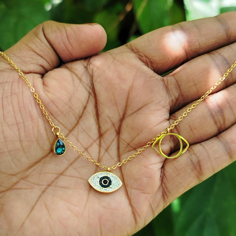 Evil Eye Golden accent Chain with Crystal Charms Held in a Hand