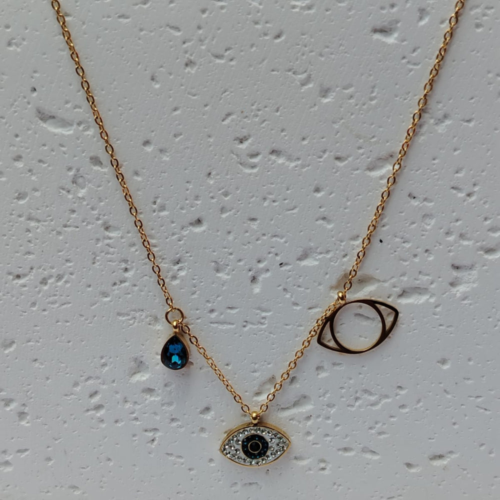 Evil Eye Blue Crystal Charm Pendant on a textured white surface