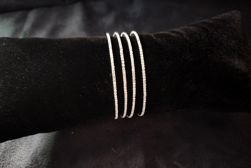Set of 4 AD Bangles on Black Velvet Cushion