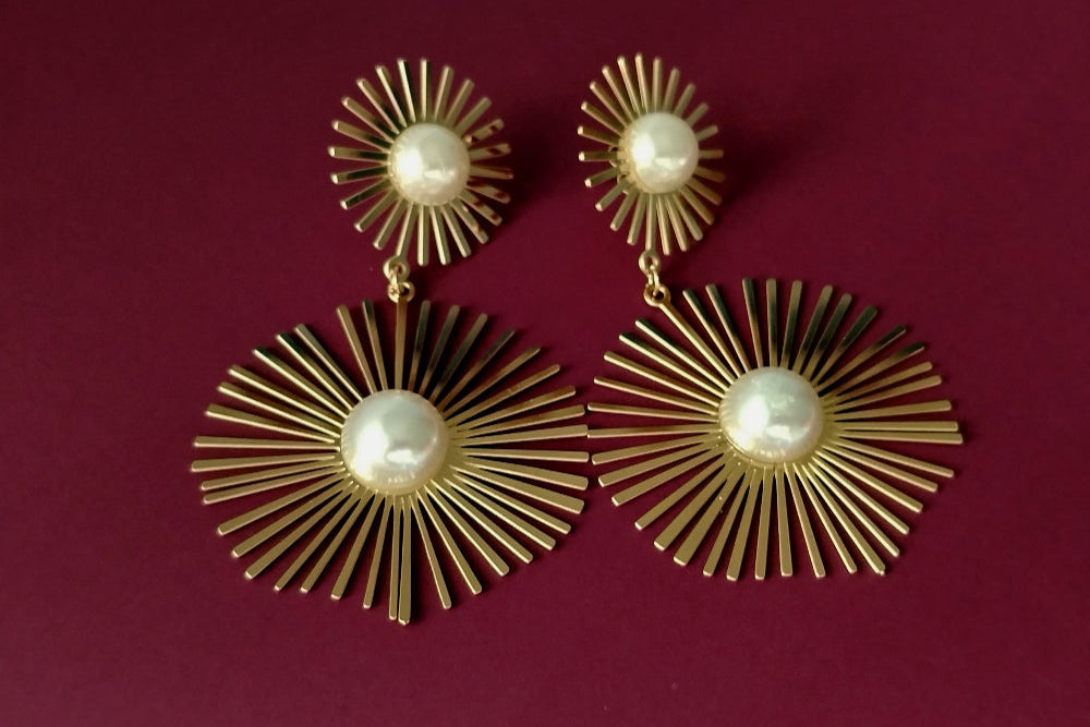 Sun-shaped Earrings with Pearl on Purple Background