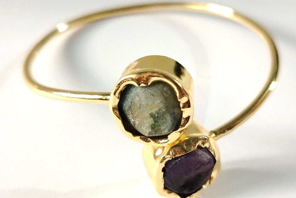 Golden Bracelet with Amethyst and Aventurine on a White background