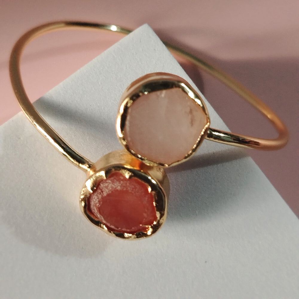 Golden Bracelet with Rose Quartz and Carnelian on a White Surface