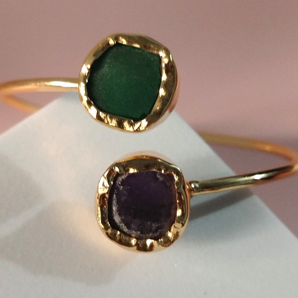 Golden Bangles with Aventurine and Amethyst on a White Block with a Pink Background