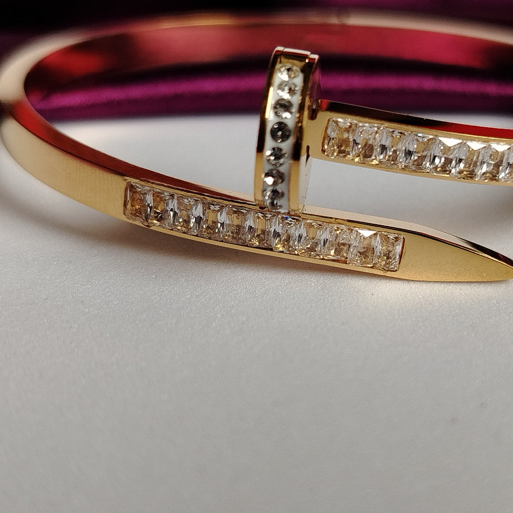 Golden Nail Bracelet with American Diamond accents on a White Background