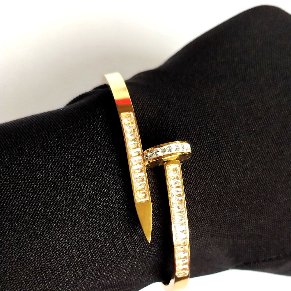 Golden Nail Bracelet with American Diamond accents on a Ladie Hand
