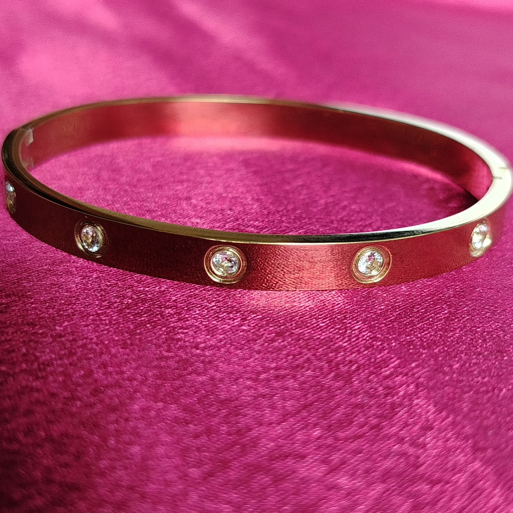 Golden AD bangle on Pink Satin Fabric