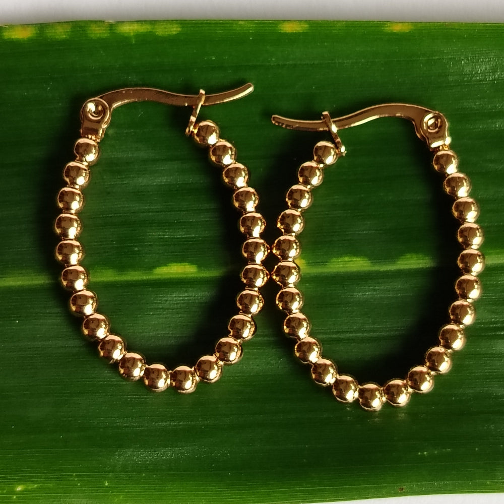 Golden Hoops on a Green Leaf
