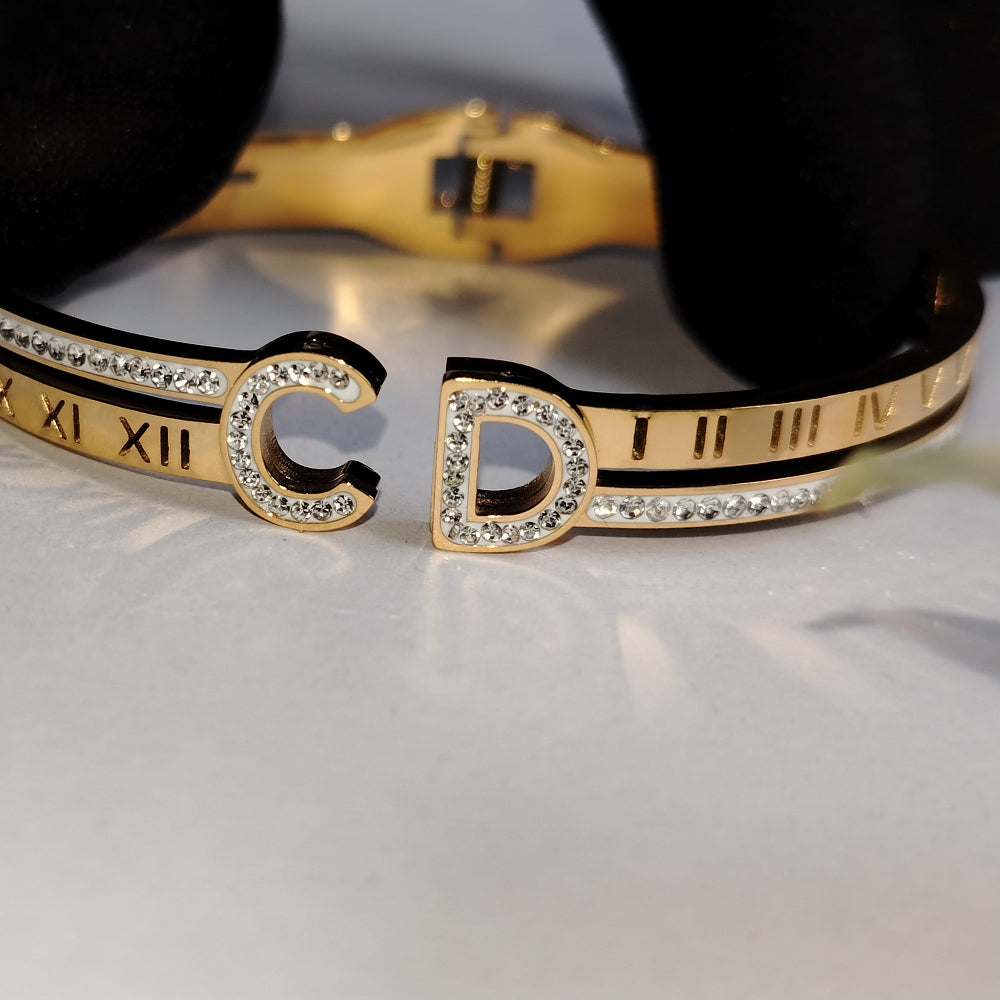 Anti-tarnish Golden Bracelet with Roman Numeral Imprints and American Diamonds on a Reflective Surface