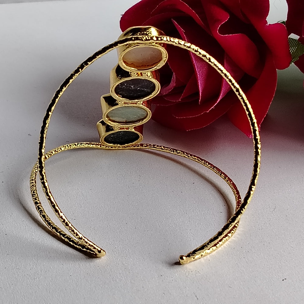 Back View of Golden Bracelet with Multi-colored Natural Stones on a White Surface