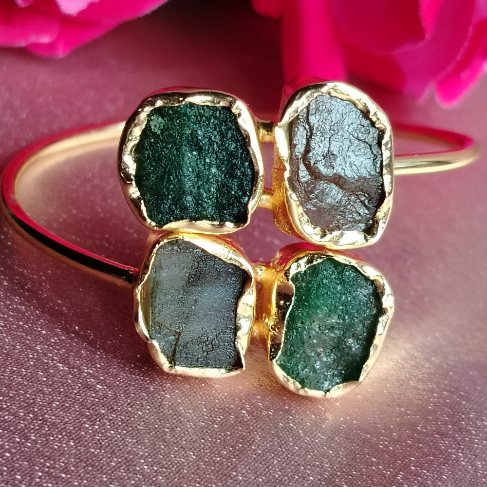 Golden Bracelet with Aventurine and Black Onyx Gemstones on a Pink Background