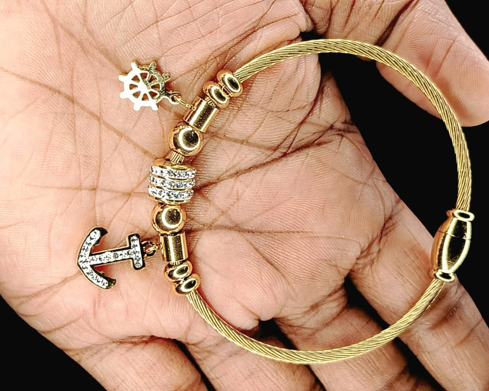 Model Holding Bracelet with Snowflakes and Anchor Charms