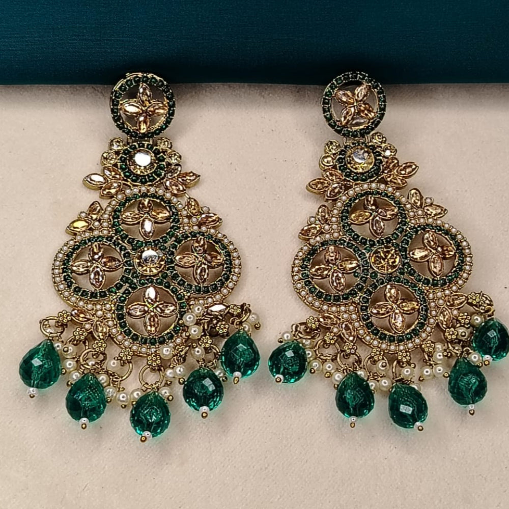 Ornate Golden and Green Earrings with Hydro Beads on a Beige Surface