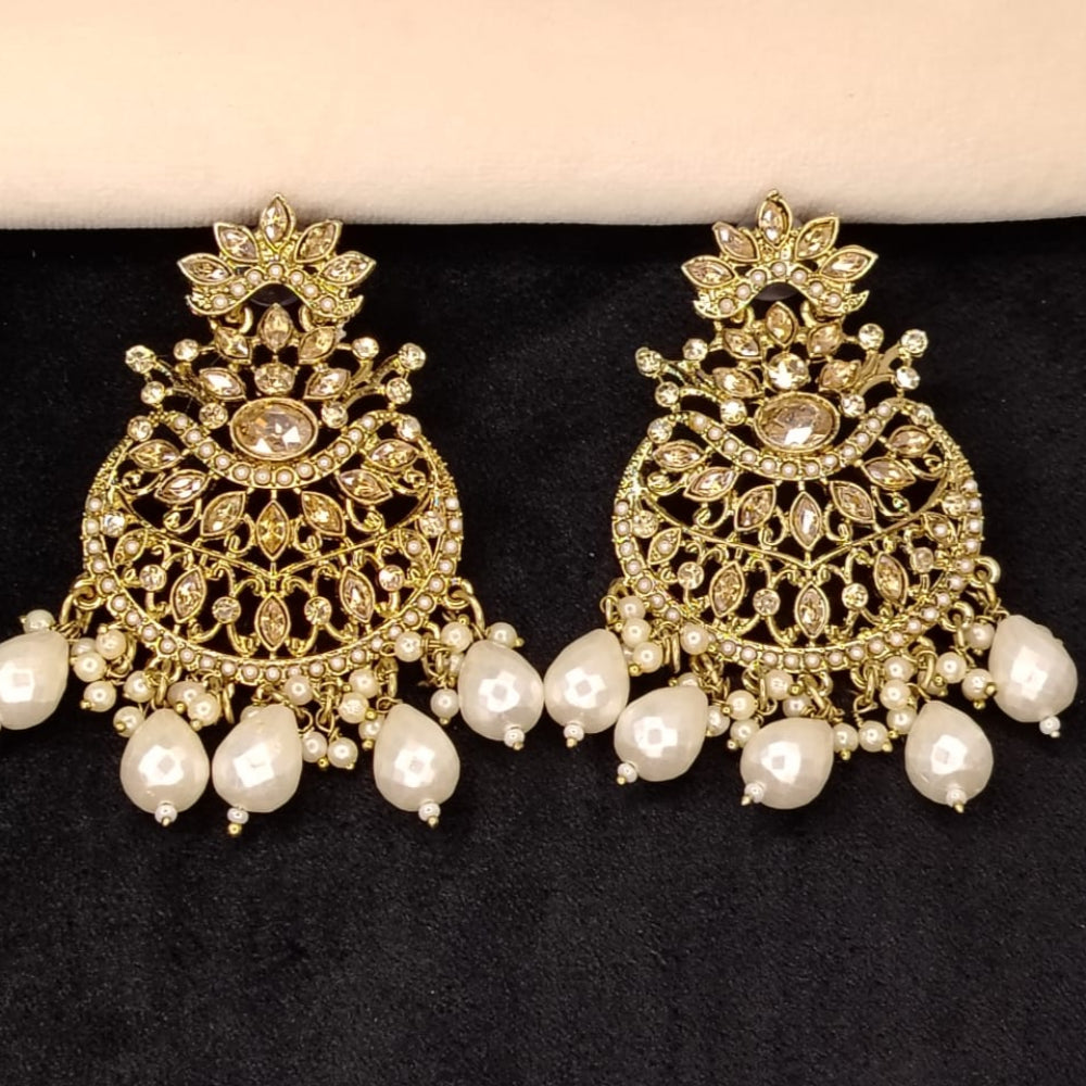 Golden Intricate Pearl Bead Earrings with Kundan Stones on Dark Surface
