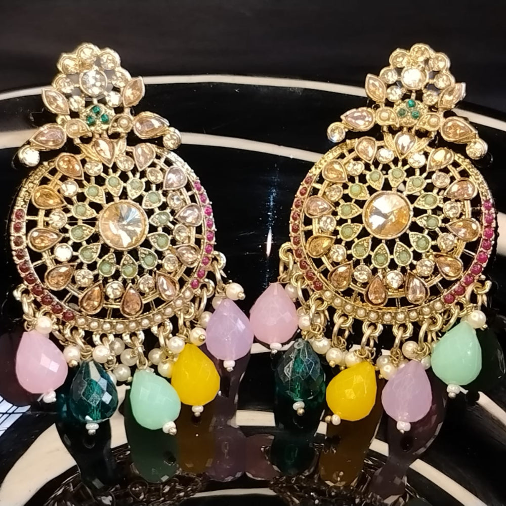 Ornate Earrings with Beads and Kundan on a Reflective Surface