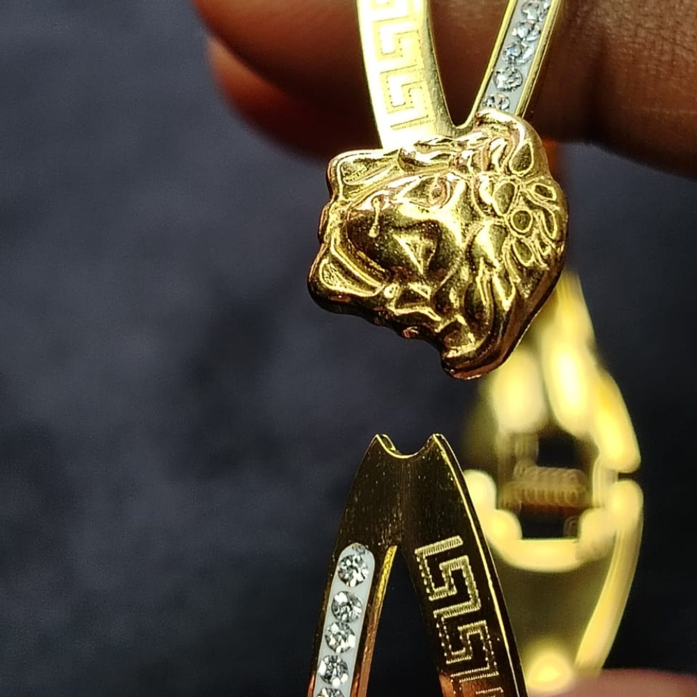 Brand Logo on Golden Bracelet Kept Open by Hand