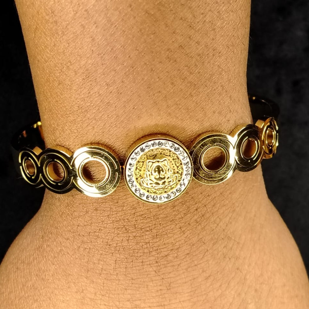 Brand-Inspired Golden Bracelet with Circular Design on the wrist against a Dark Background