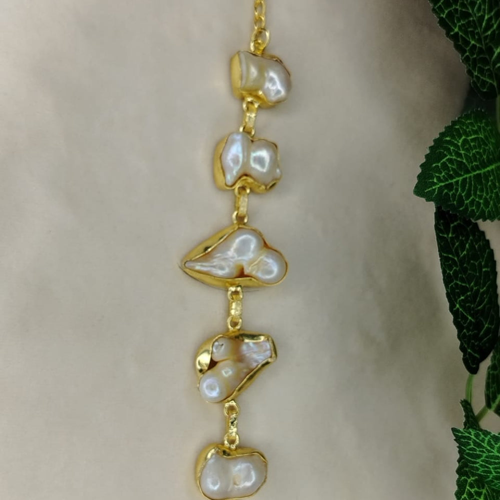 Golden Bracelet. with Natural Pearls on a Beige Background