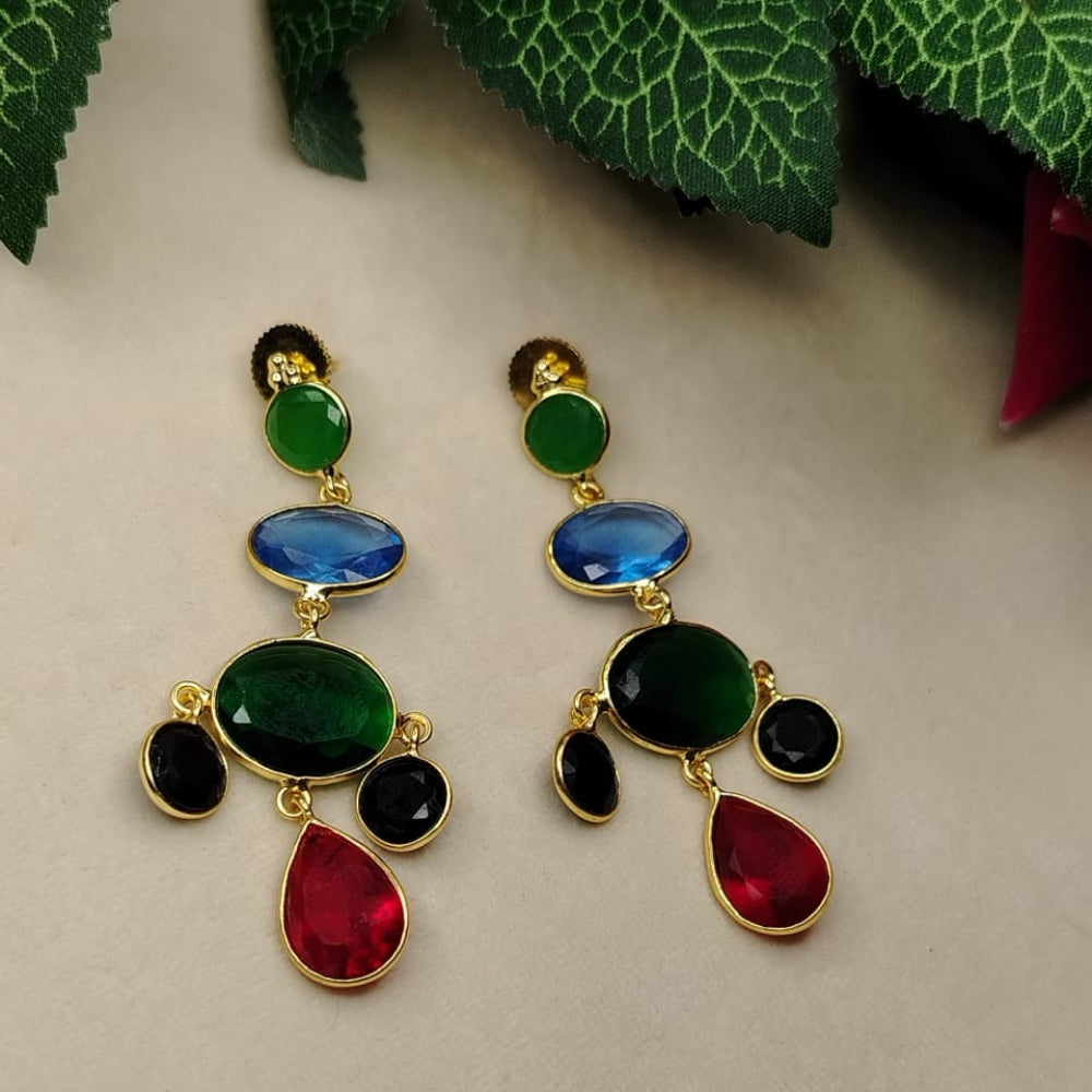 Colorful Crystal Earrings on Beige Surface with Green Leaves