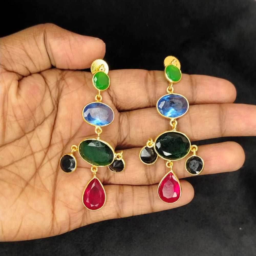 Colorful Gemstone Earrings with Ruby Drops Held in Hands against Black Background