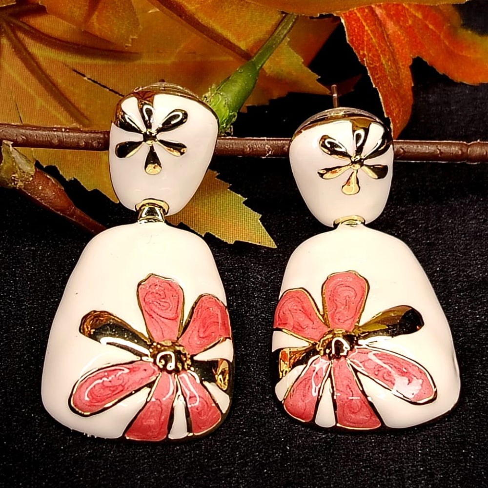 White Base Pink Floral Earrings on Black Surface and Autumn Leaves