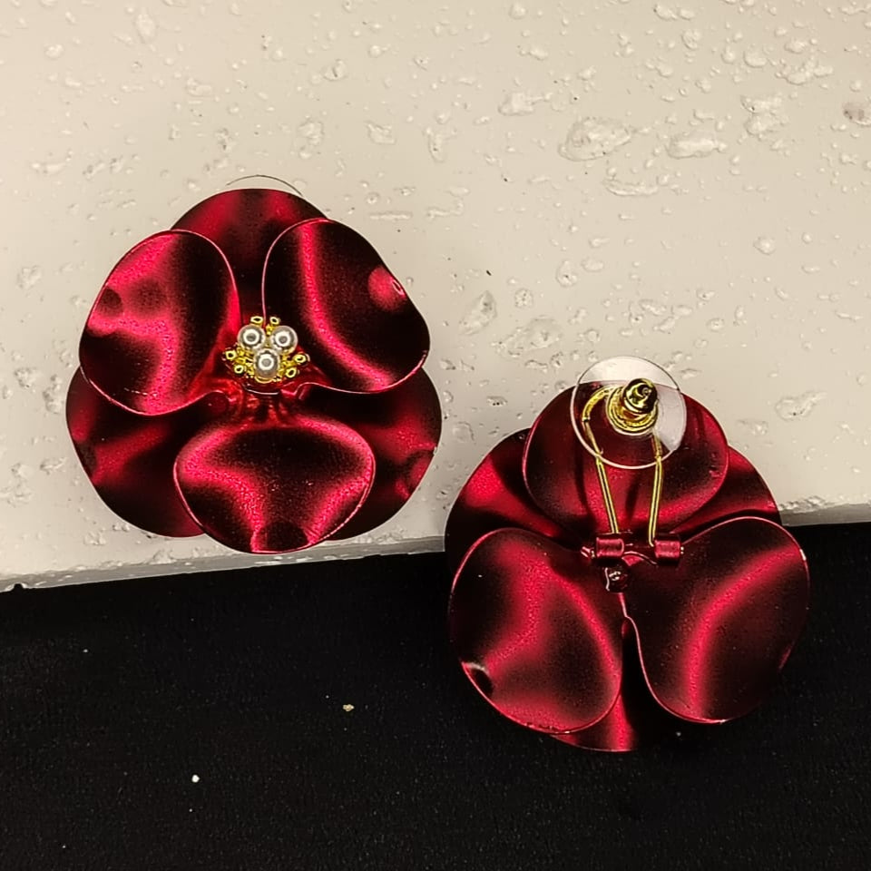 Back View of Maroon FLower Earrings on a White Textured Background