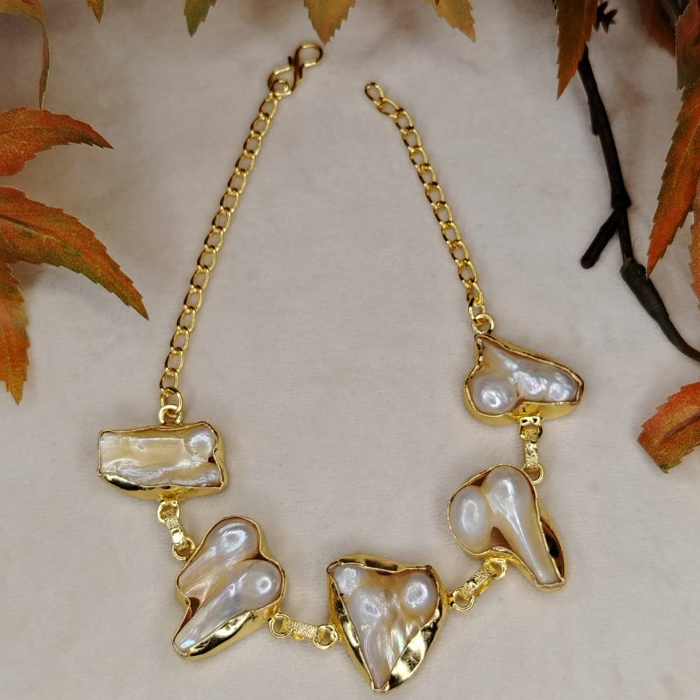 Golden Baroque Pearl Bracelet on Beige Background