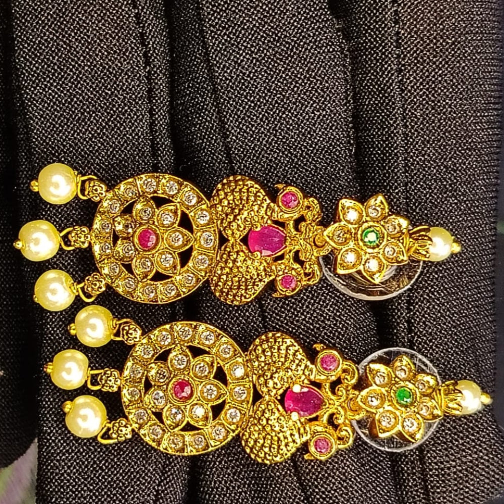 Golden Earrings with Crystals and Pearl Beads on a Black Background