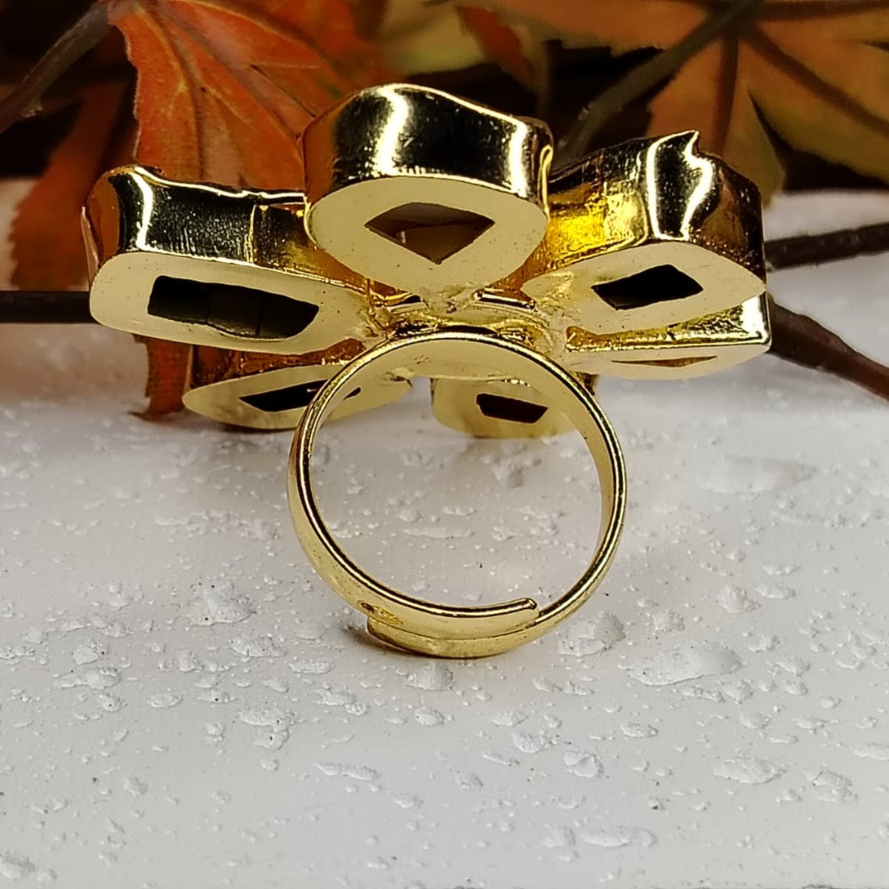 Back View of Golden Flower Ring on a White Surface