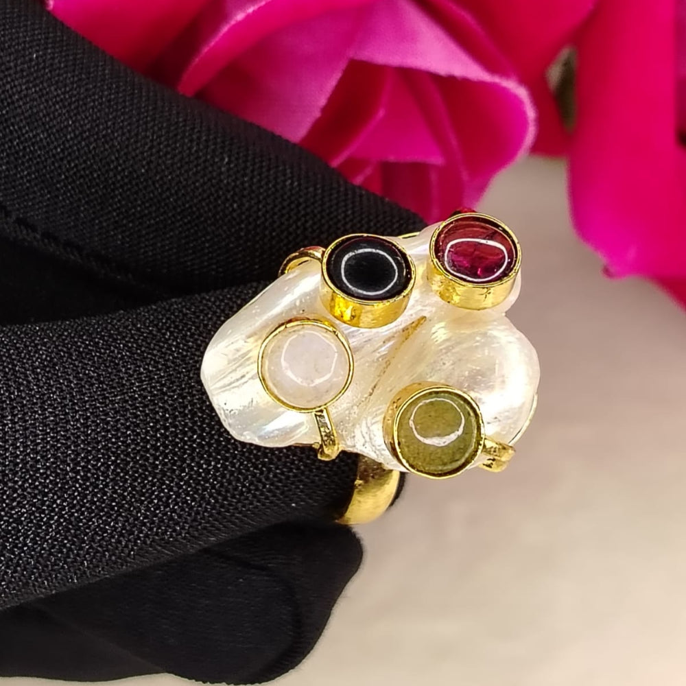 Golden Pearl Ring with Multicolored Semi-precious Stones Held by Black Gloved Hands against Roses
