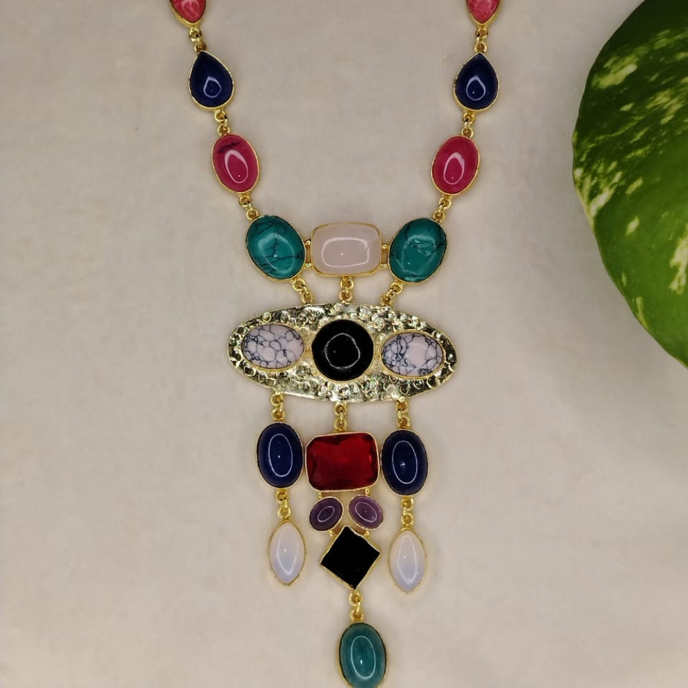 Golden Neckpiece with Colourful Natural Stones on a Beige Background with Leaves