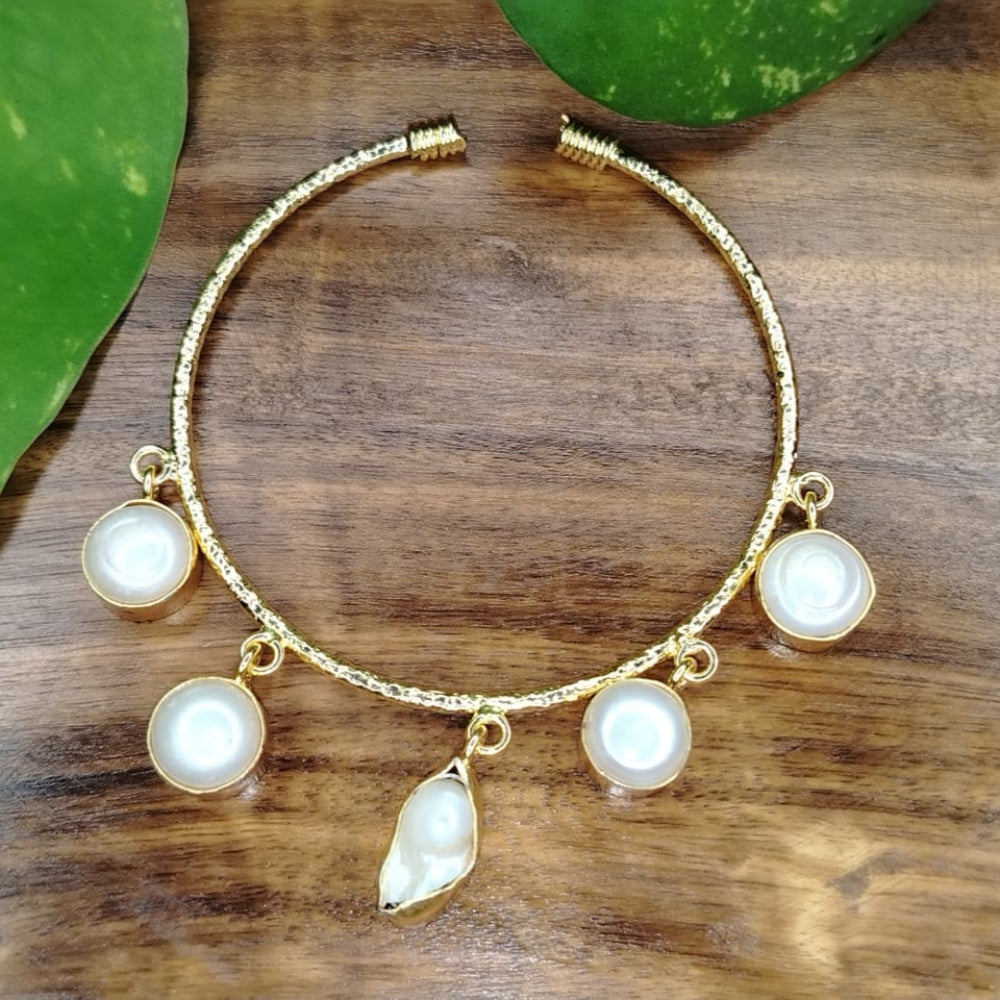 Golden Bracelet with natural Pearl Charms on Wooden Surface