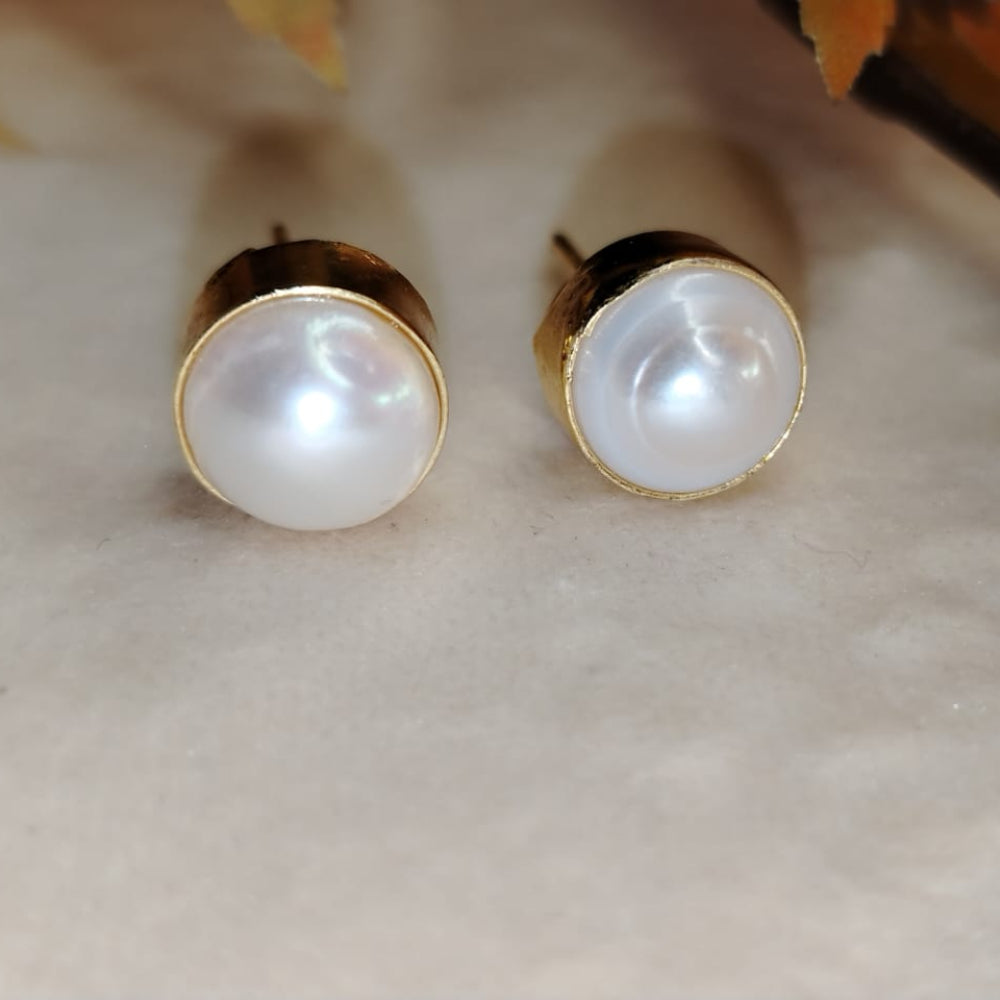 Natural Pearls Earrings on a Beige Background