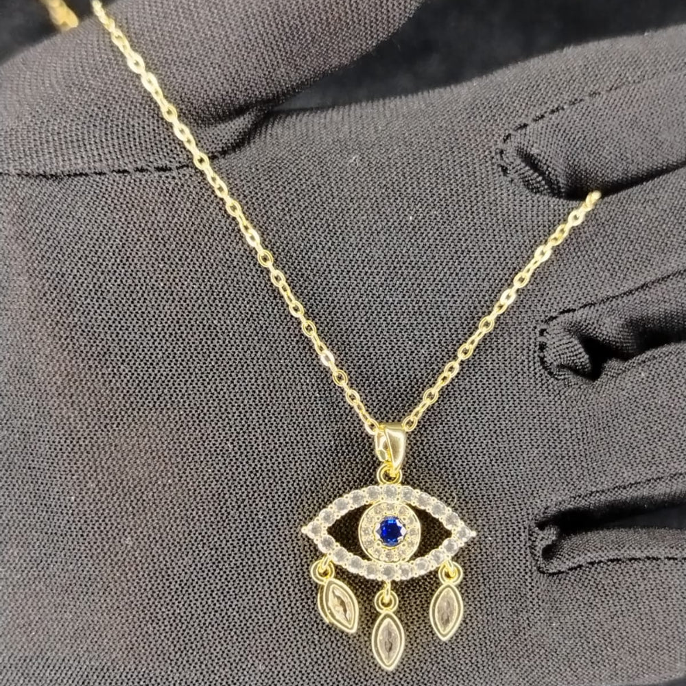 Golden Tear Drop Eye Pendant with American Diamonds Held by Gloved Hand