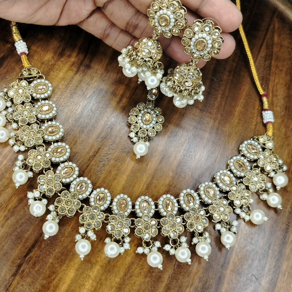 Golden Pearl Beads and Kundan Jewellery Set on A Wooden Surface