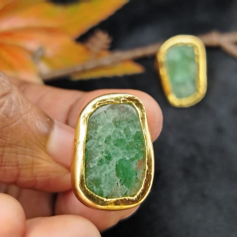 Gold-framed Aventurine Studs Held in Hand