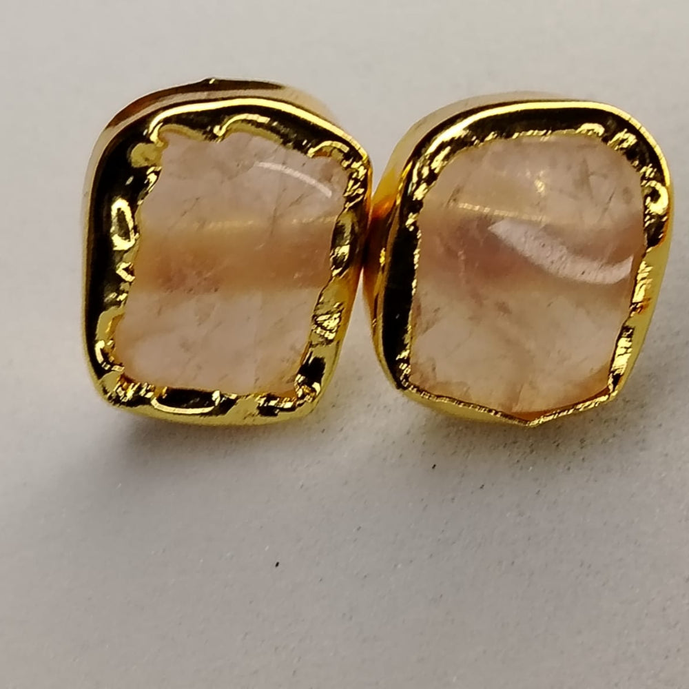 Gold-framed Pink Stone earrings on aWhite Surface