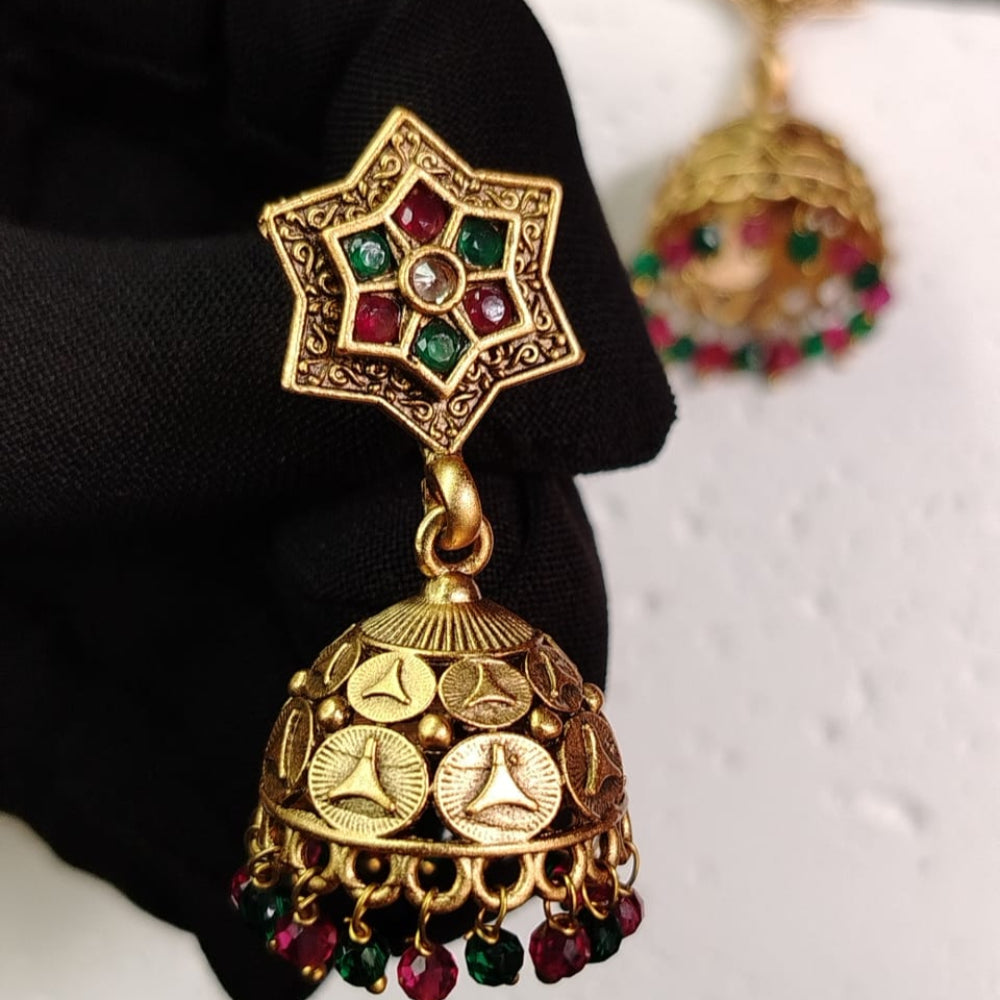 Golden jhumka earrings with a star-shaped top and coin designs on a black background