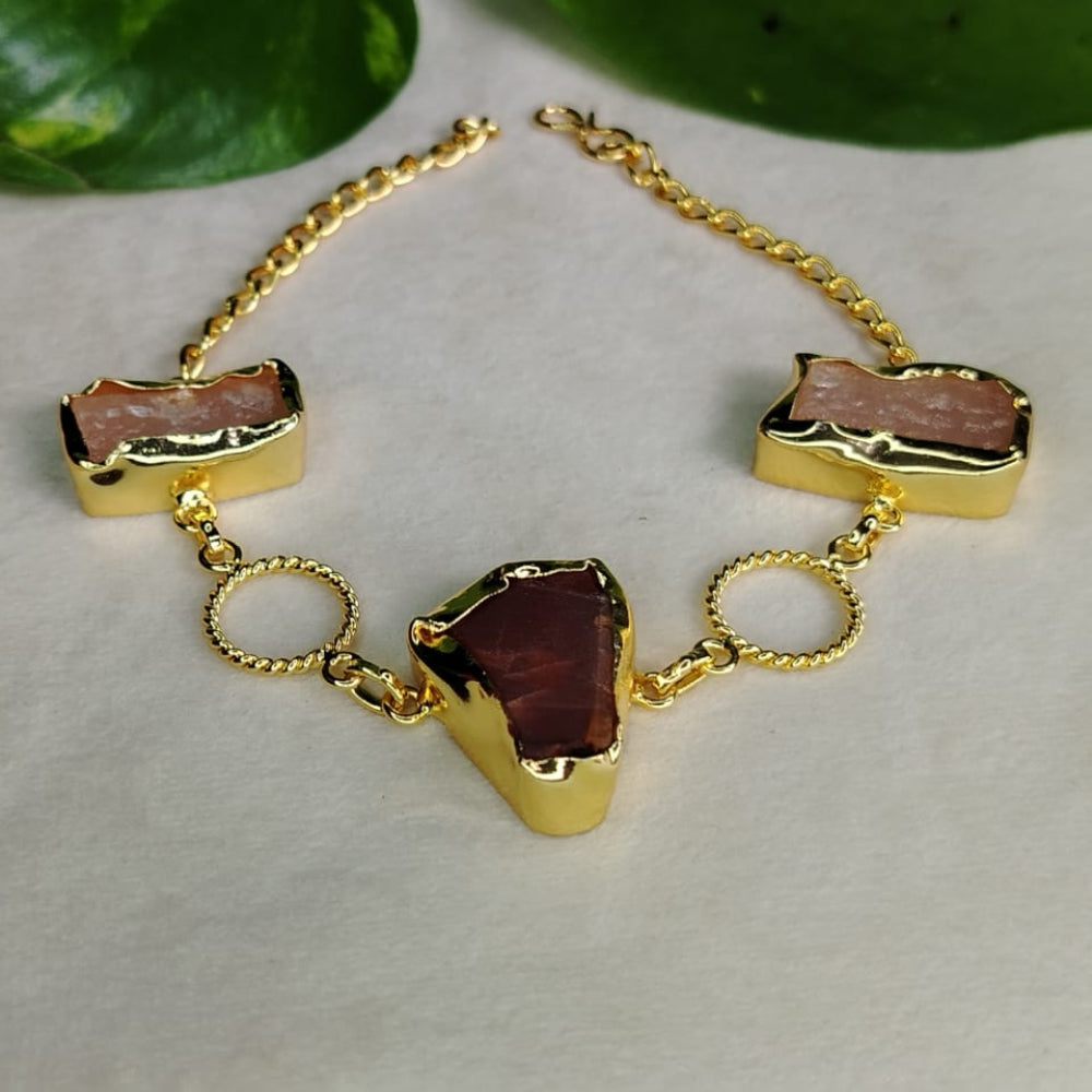 Gold bracelet with Rose Quartz and Garnet Stone on a neutral background