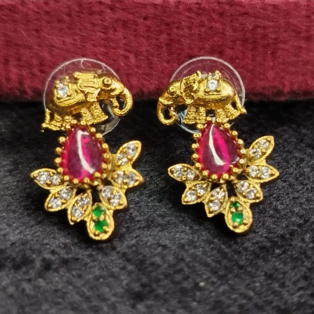 Golden Earrings with Red and Green Gemstones on Red and black Surface