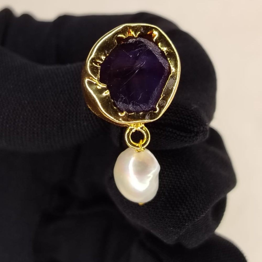 Gold-framed Amethyst Earrings with pearl Drop held in Black Gloved hand