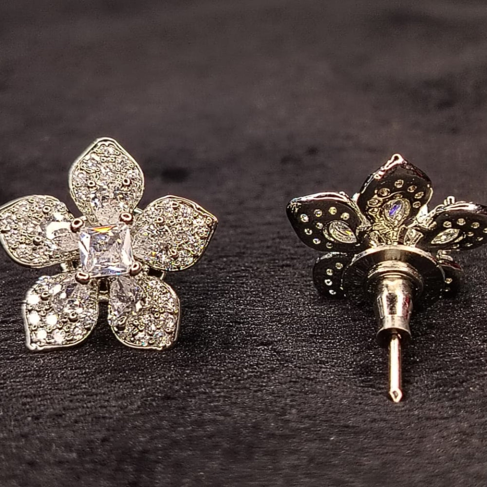 Flower-shaped earrings with Clear Crystals on a grey Background