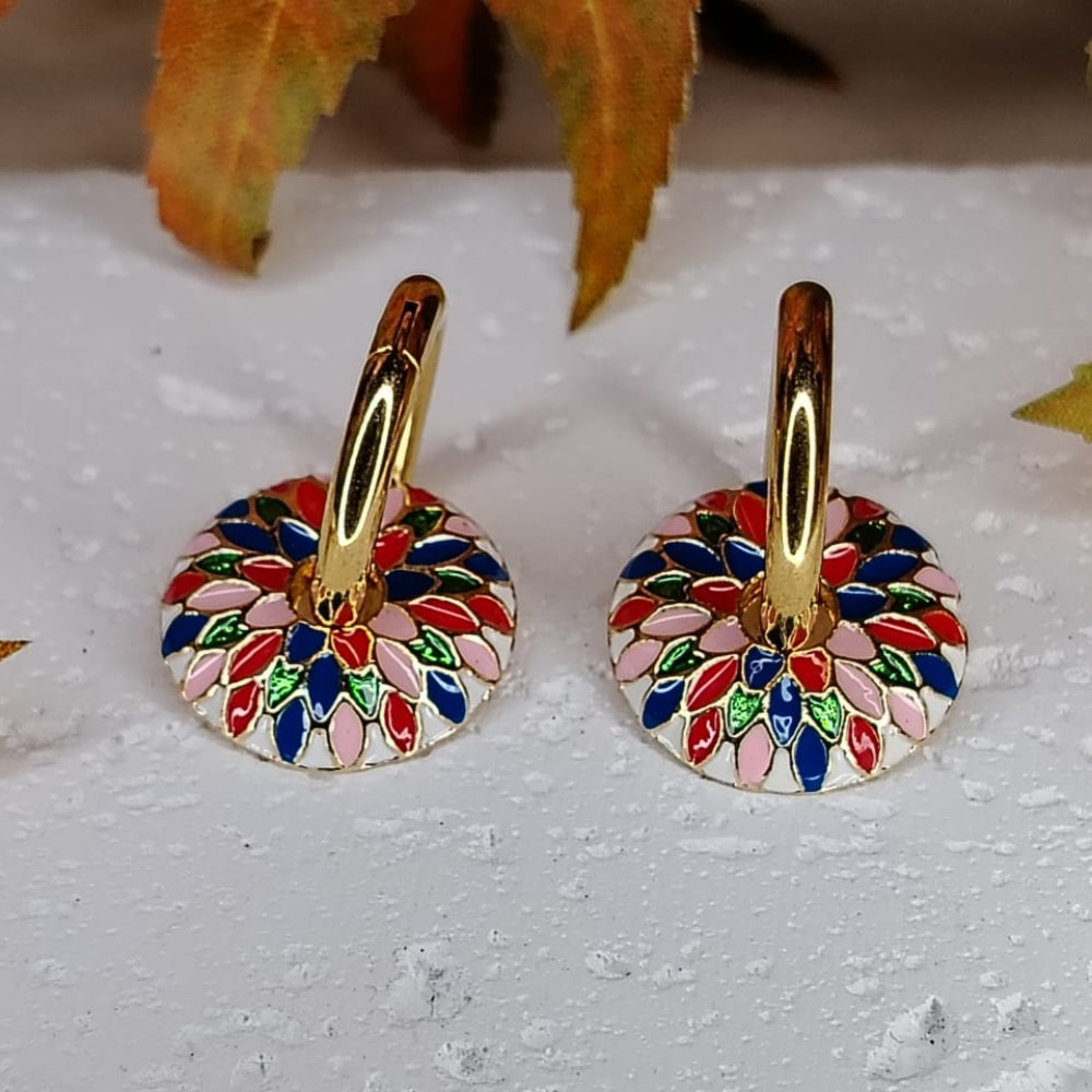Colorful floral-patterned Enamel Hoops on a textured surface with leaves in the background