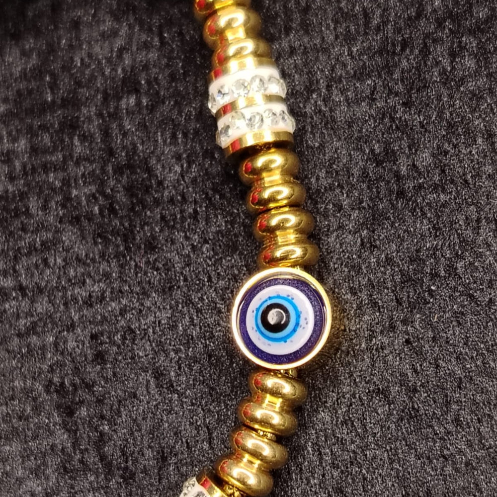 Necklace with gold, blue, and white beads on a dark background