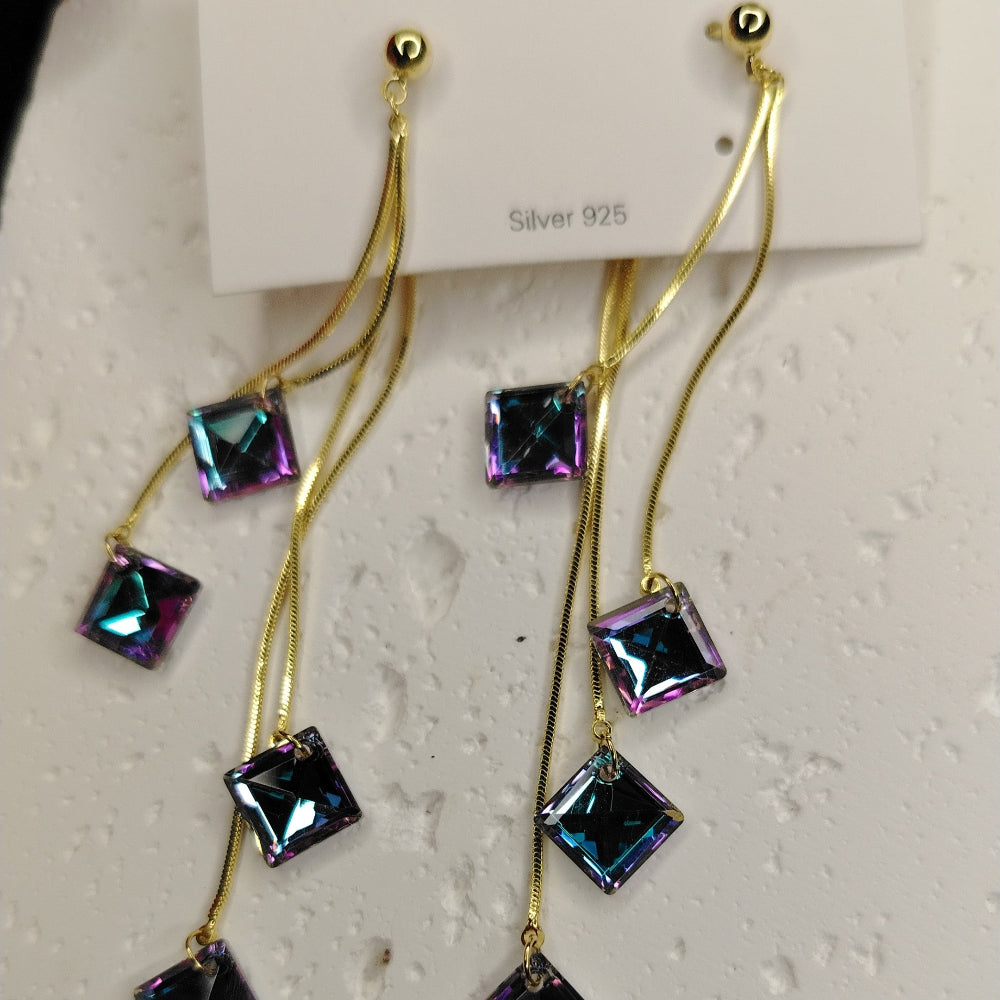 Long Golden Earrings with Rainbow Crystals on a white card
