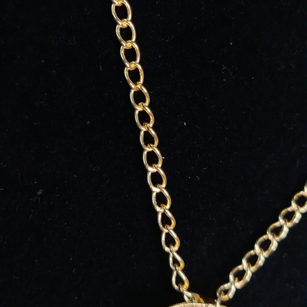 Gold chain necklace on a black background