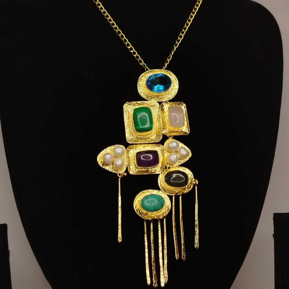 Gold necklace with gemstones on a black mannequin