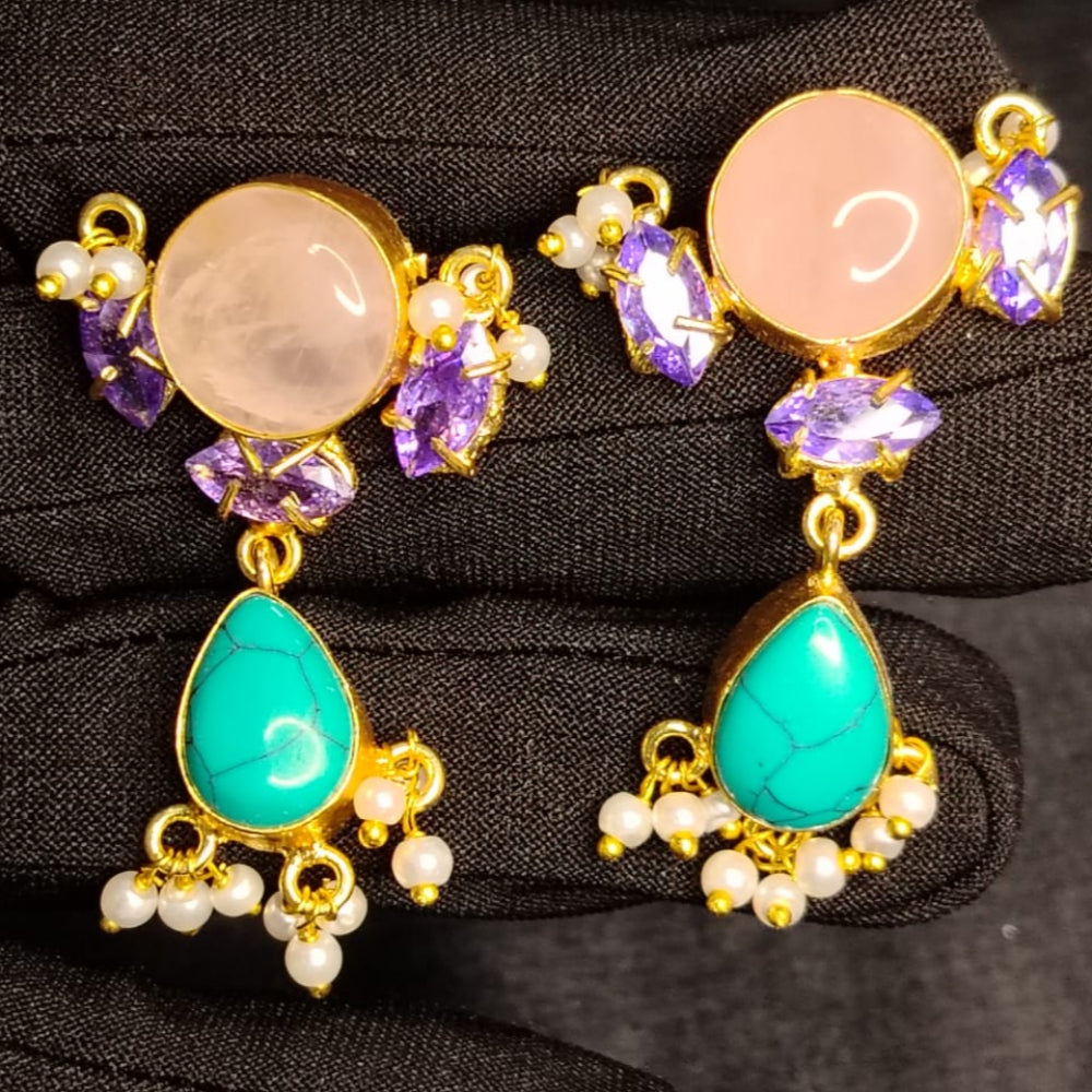 Pair of earrings with gemstones on a black background