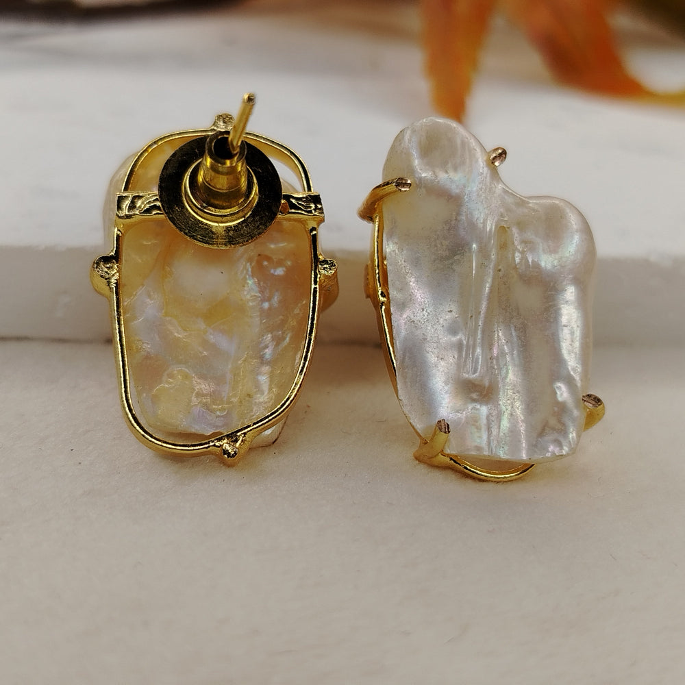 Gold-framed natural pearl earrings on a light background