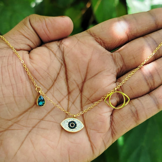 Evil Eye Golden accent Chain with Crystal Charms Held in a Hand