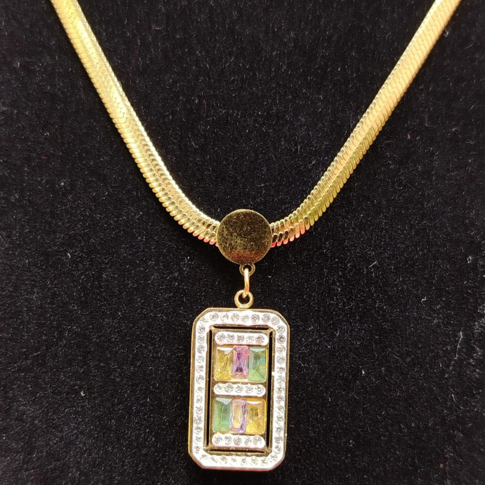 Gold necklace with a rectangular pendant on a black background